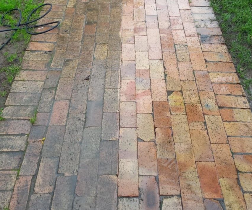 Brick walkway half pressure cleaned, with the clean section next to the dirty section