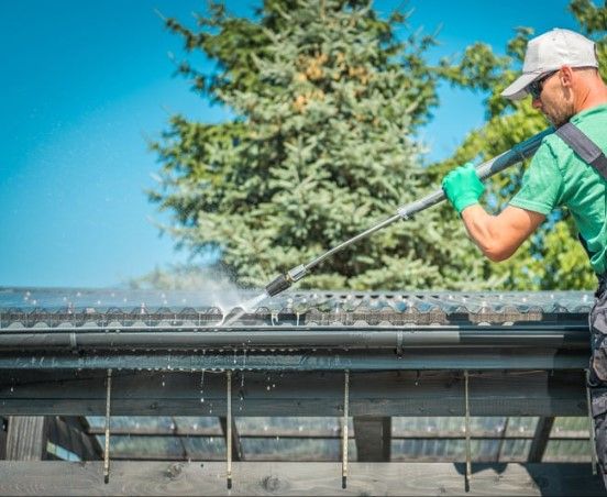 Gutter being cleared of leaves and sludge
