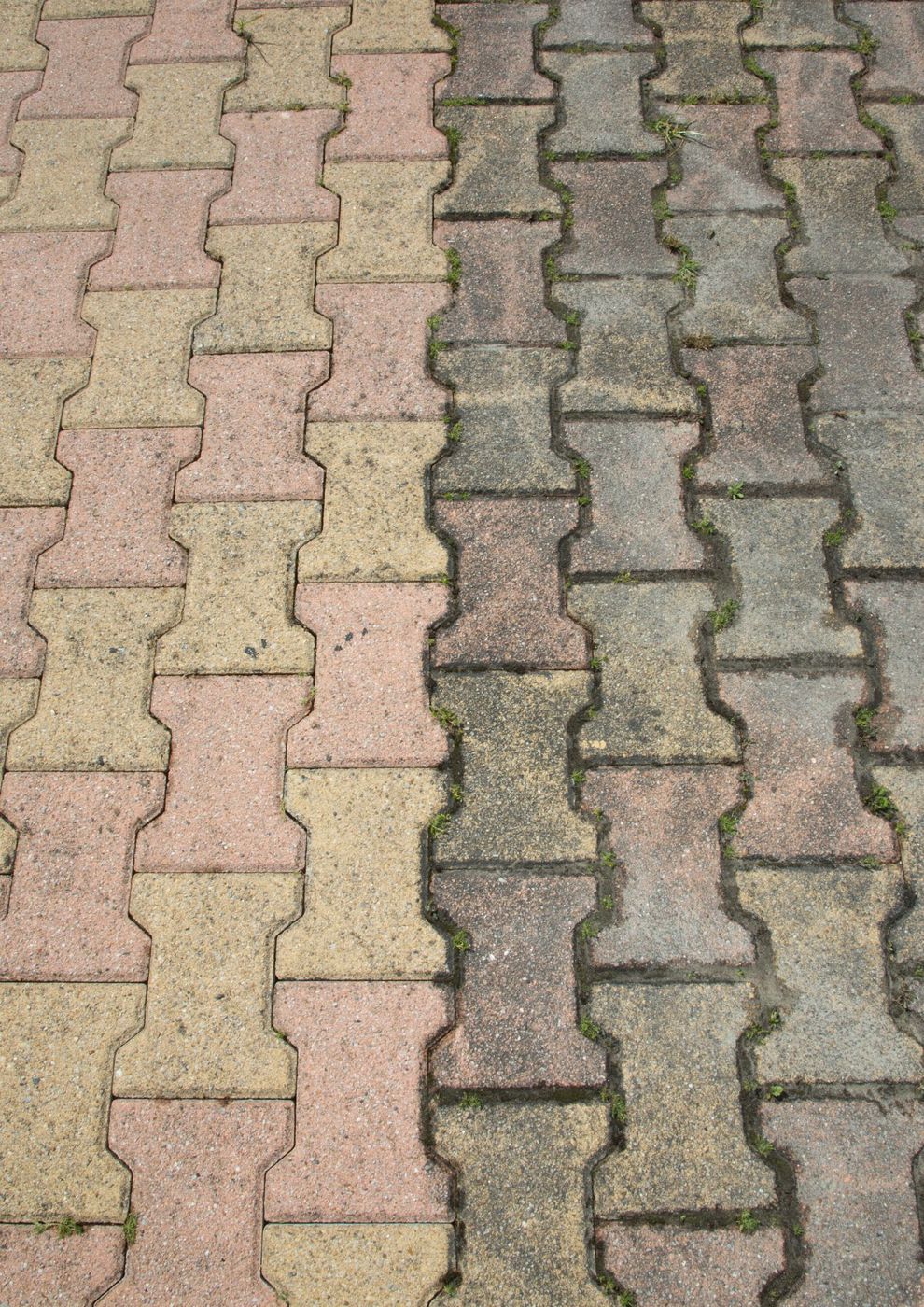 Interlocking paving half pressure cleaned, showing dirty and clean sections side by side