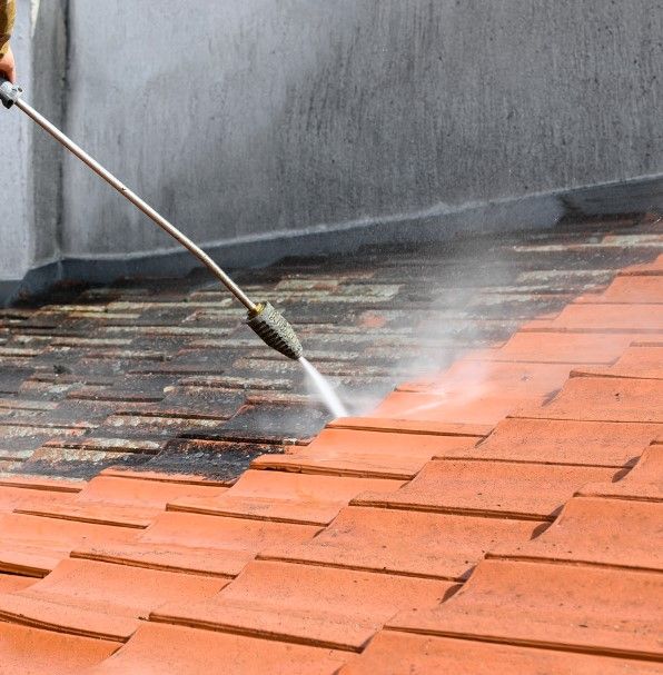 Tiled roof being cleaned with a low-pressure washer