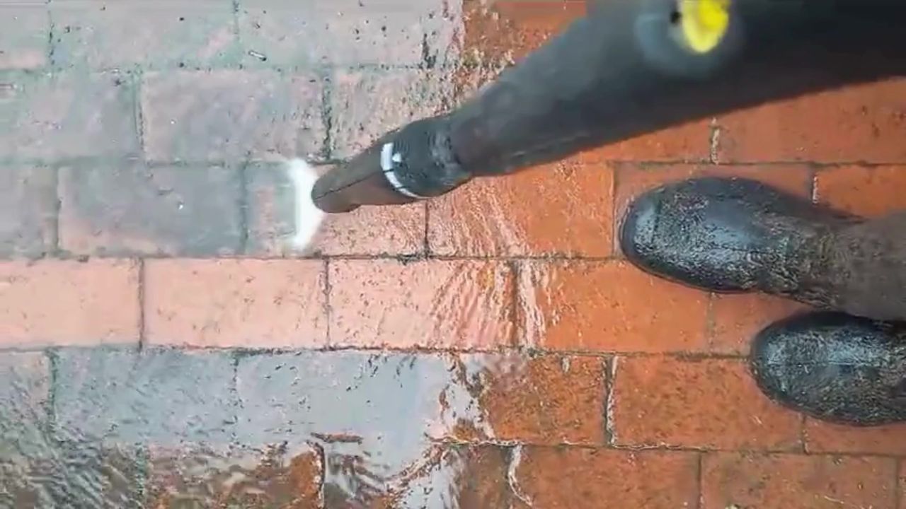 Grey to red: watch the clean line move across the paving.