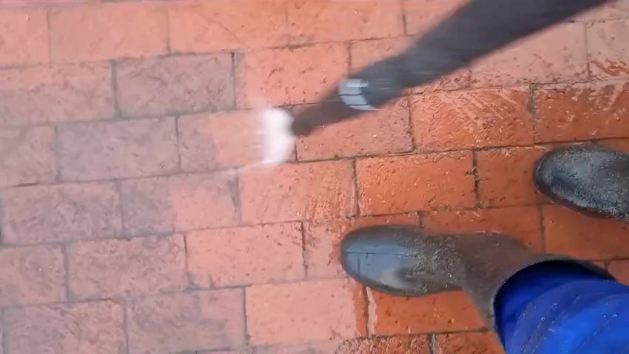 Pressure cleaning red brick paving
